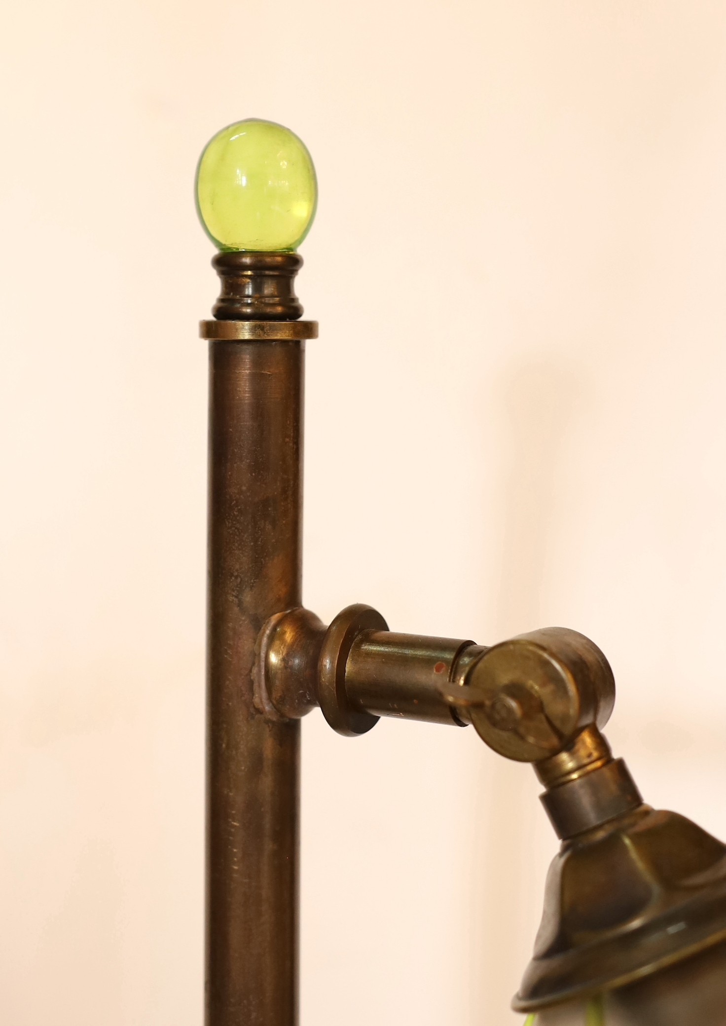 A 1930's English brass desk lamp with Art Nouveau style glass shade, height 58cm